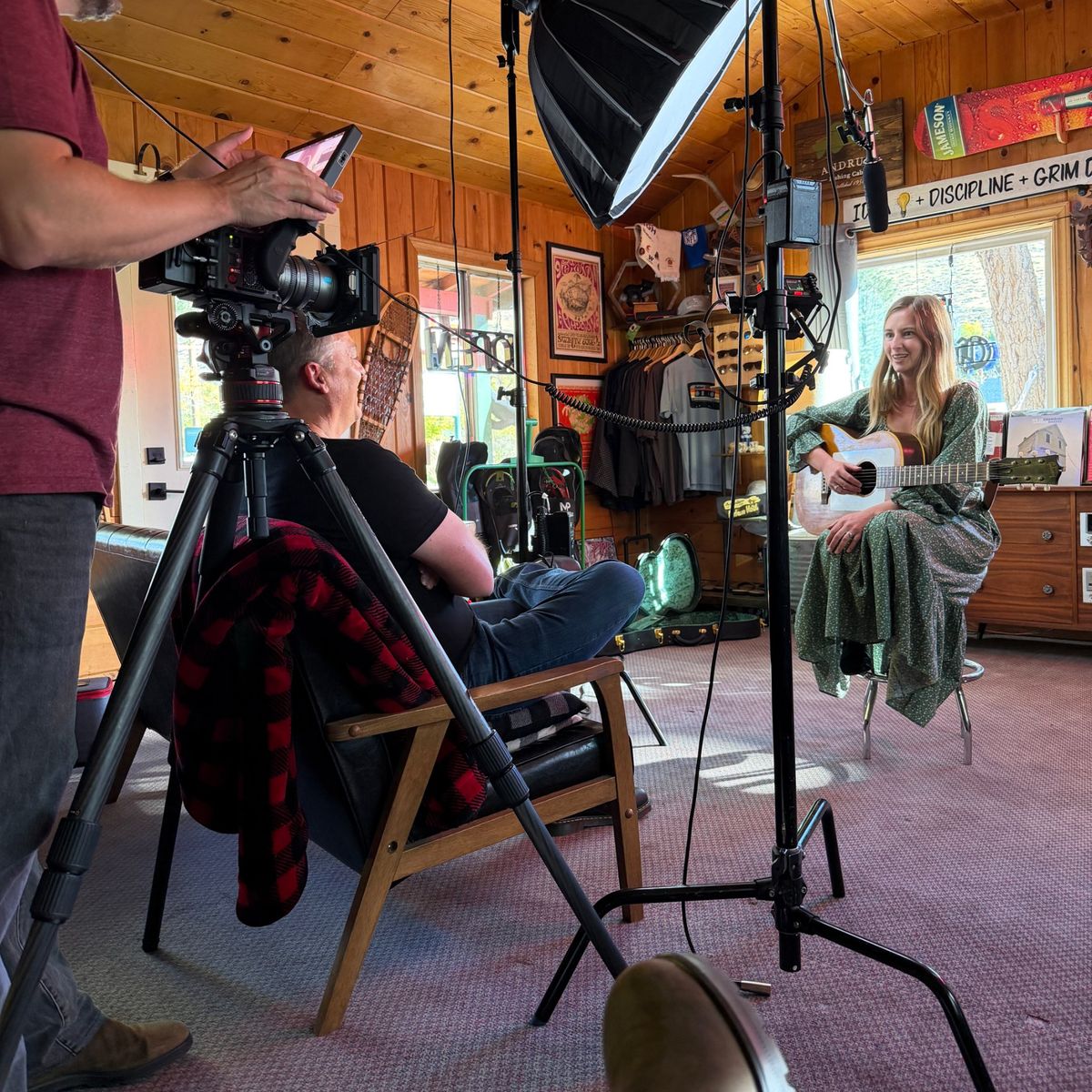 Filming at the Andruss Motel: a guitarist answers questions under a softbox while the camera operator checks the shot.